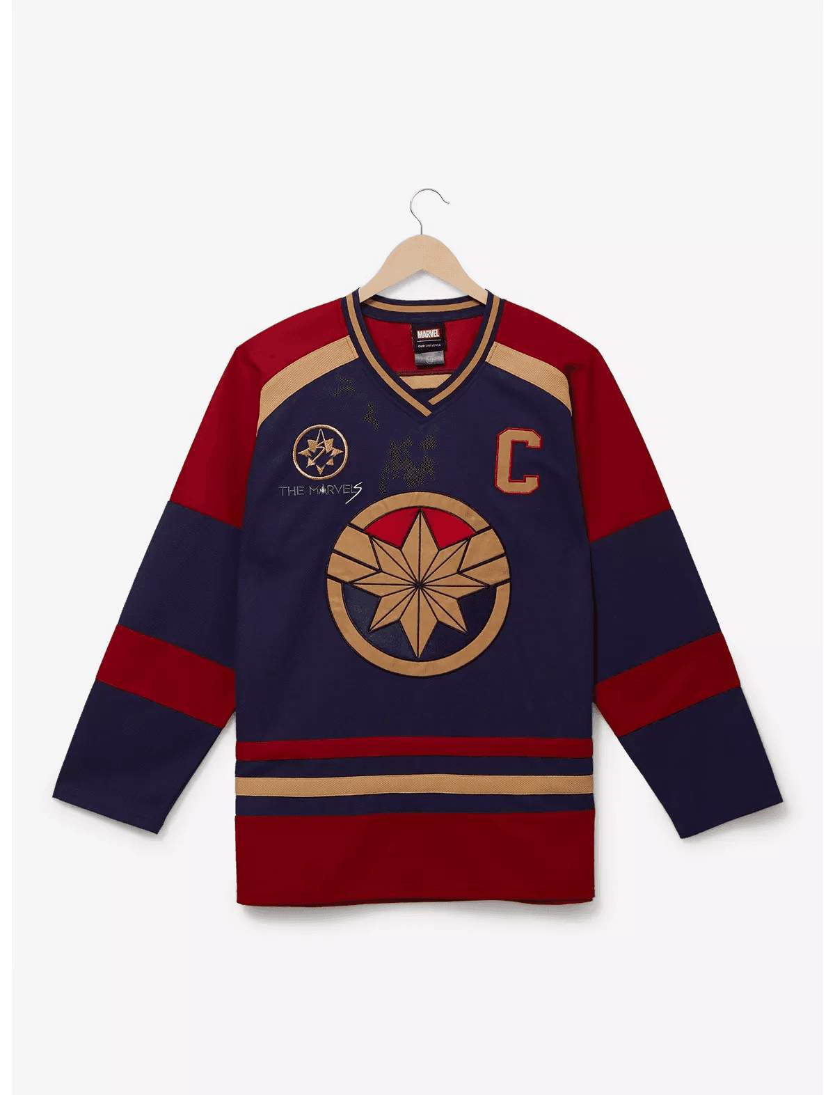 Shop it <a href=https://www.boxlunch.com/product/marvel-the-marvels-carol-danvers-hockey-jersey---boxlunch-exclusive/20560904.html>here</a>